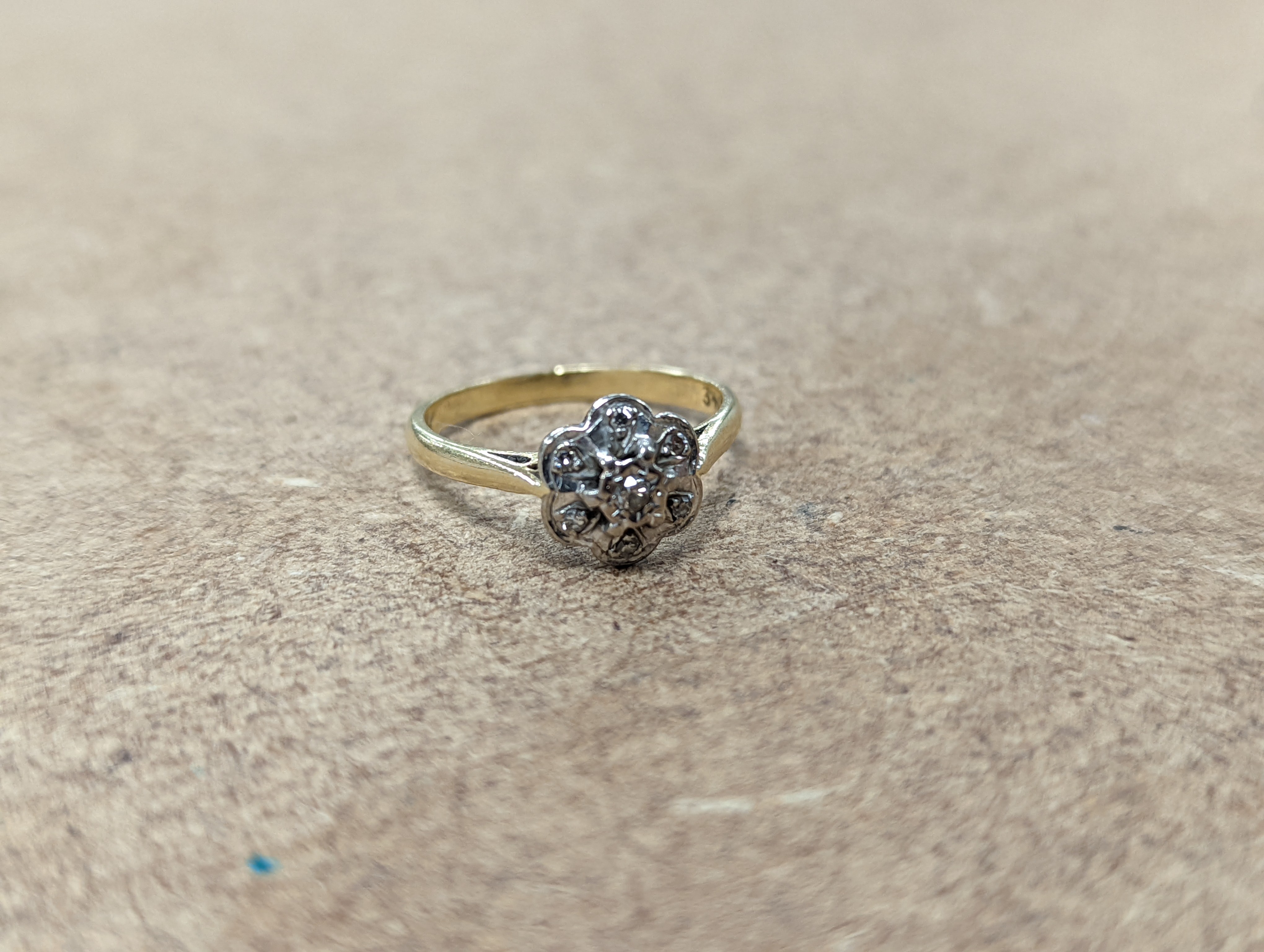 Two 18ct and diamond cluster rings, gross 5.3 grams, a 585 and diamond chip ring, gross 1.7 grams, a 9ct gold gem set ring and two 9ct pendants, gross 8.9 grams.